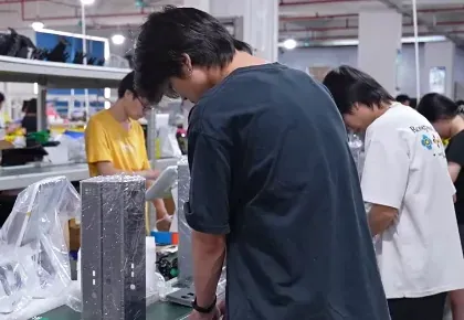 Operators assembling mobile POS hardware on the factory floor